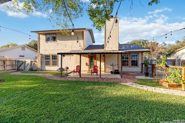 back of property featuring a lawn and a patio area