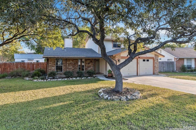 view of front facade with a garage and a front lawn