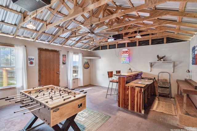 game room featuring beamed ceiling and high vaulted ceiling