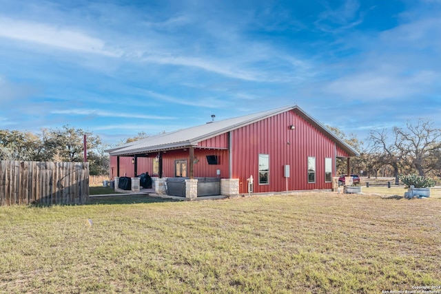 view of side of property with a lawn and an outdoor structure