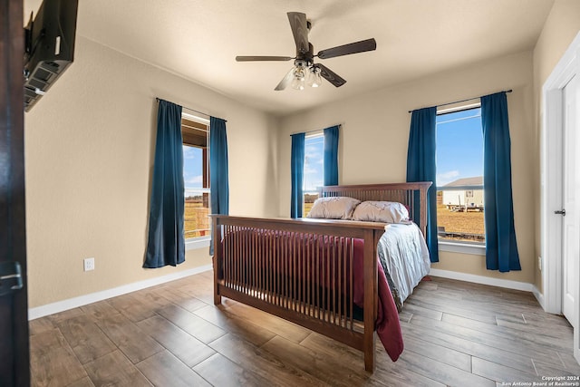 bedroom with wood-type flooring and ceiling fan