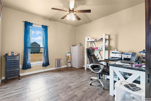 office space with wood-type flooring and ceiling fan