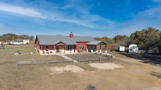 view of front of home with a storage unit