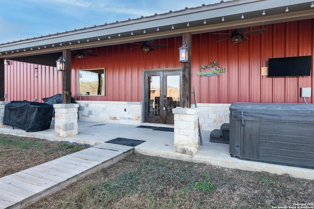 doorway to property featuring a hot tub and ceiling fan