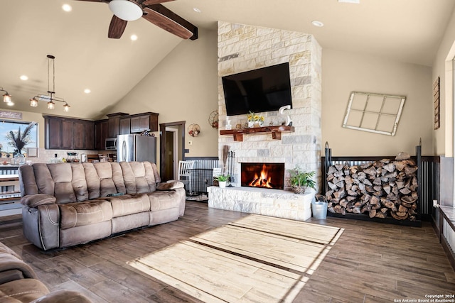 living room featuring a fireplace, dark hardwood / wood-style flooring, ceiling fan, and beamed ceiling