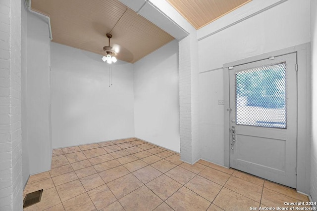 tiled foyer entrance with ceiling fan and wooden ceiling