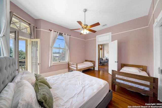 bedroom with ceiling fan, dark hardwood / wood-style flooring, and access to outside