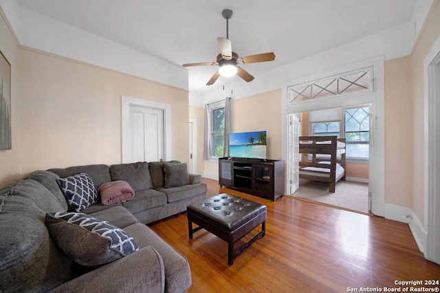 living room featuring wood-type flooring and ceiling fan