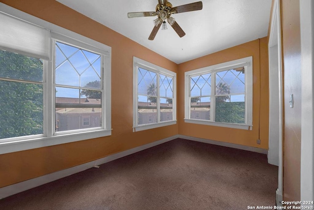 unfurnished sunroom featuring ceiling fan