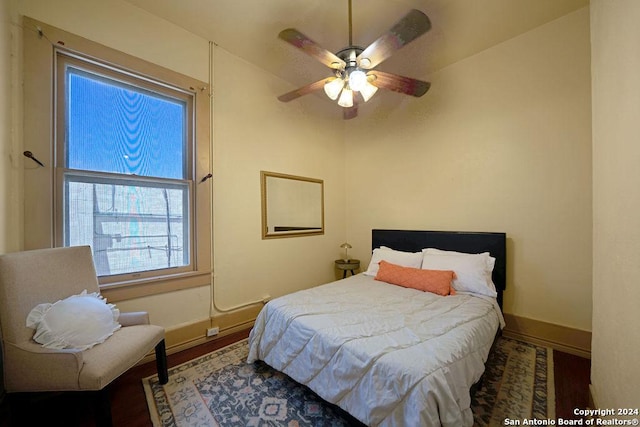 bedroom with ceiling fan and wood-type flooring