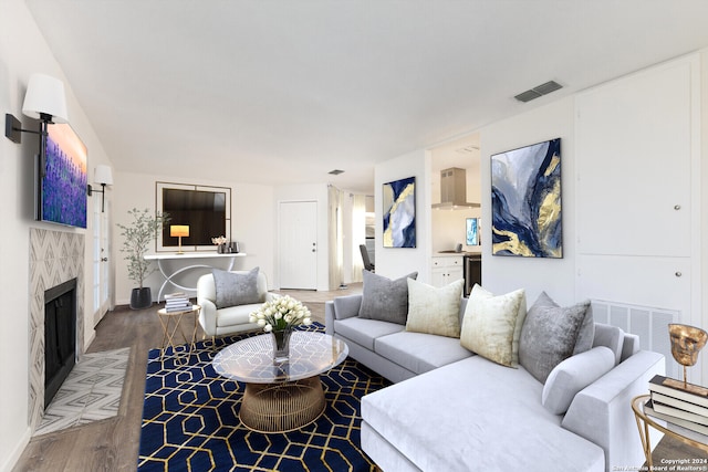 living room with a fireplace and wood-type flooring