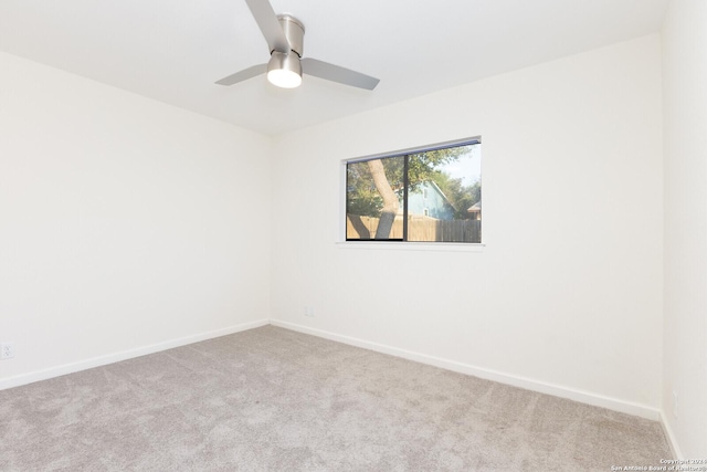 unfurnished room featuring light carpet and ceiling fan