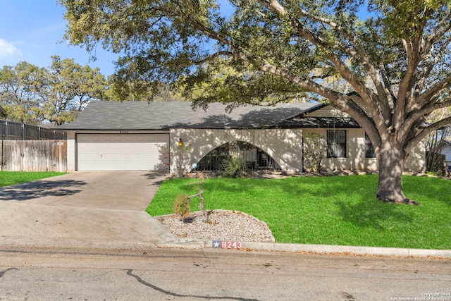 view of front of home featuring a garage and a front lawn