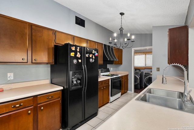 kitchen featuring pendant lighting, sink, white gas range, separate washer and dryer, and black fridge with ice dispenser