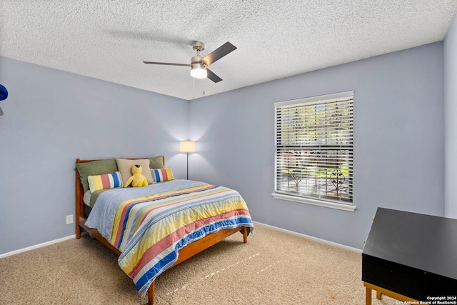 bedroom featuring carpet flooring, a textured ceiling, and ceiling fan