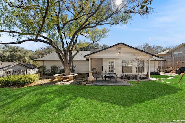 back of house with a lawn and a patio area