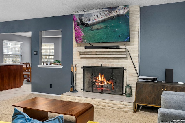 carpeted living room featuring a fireplace and a textured ceiling