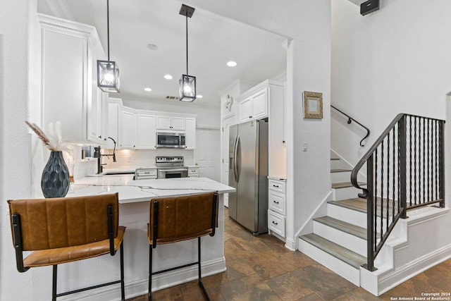 kitchen with sink, hanging light fixtures, stainless steel appliances, tasteful backsplash, and white cabinets