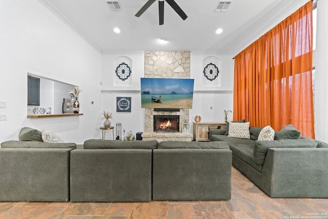 living room with ceiling fan, a fireplace, and ornamental molding