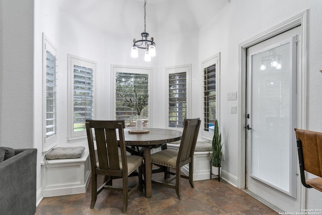 dining space featuring a notable chandelier and vaulted ceiling