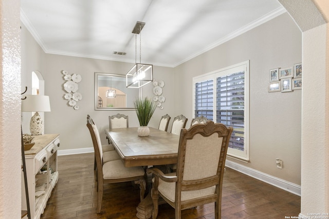 dining space with ornamental molding, dark wood-type flooring, and a chandelier