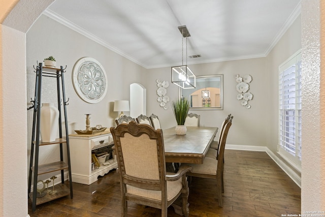 dining room with dark hardwood / wood-style floors and crown molding