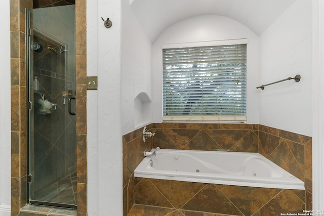 bathroom with separate shower and tub and lofted ceiling