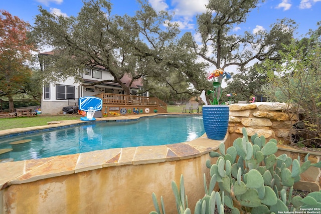 view of swimming pool featuring a deck