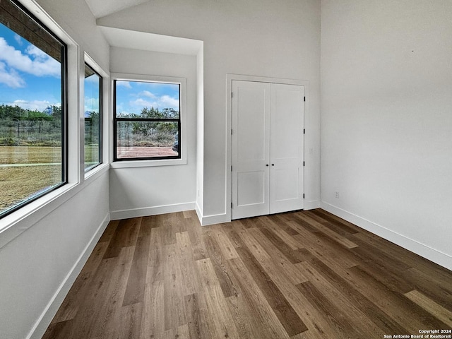 unfurnished bedroom with a closet and hardwood / wood-style floors