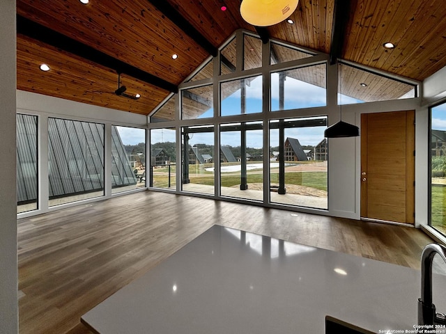 interior space featuring beamed ceiling, plenty of natural light, and high vaulted ceiling