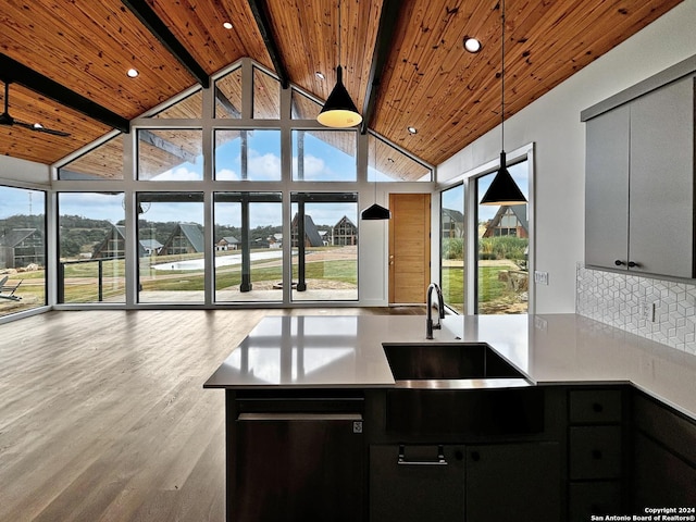 kitchen with beam ceiling, sink, wooden ceiling, decorative light fixtures, and decorative backsplash