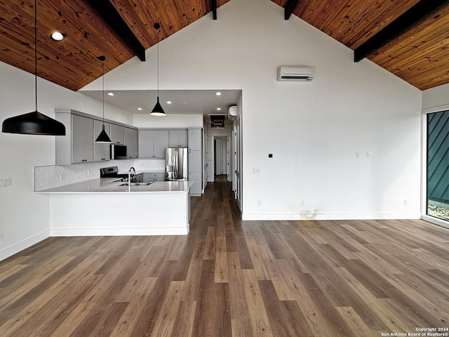 kitchen with gray cabinetry, kitchen peninsula, stainless steel appliances, and dark wood-type flooring