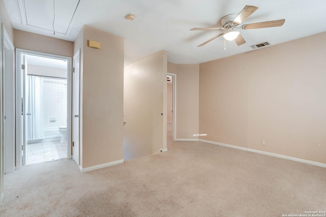 carpeted spare room with ceiling fan