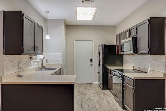 kitchen featuring sink, light hardwood / wood-style flooring, black electric range, decorative light fixtures, and dark brown cabinets