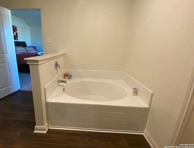 bathroom featuring a bathing tub and wood-type flooring