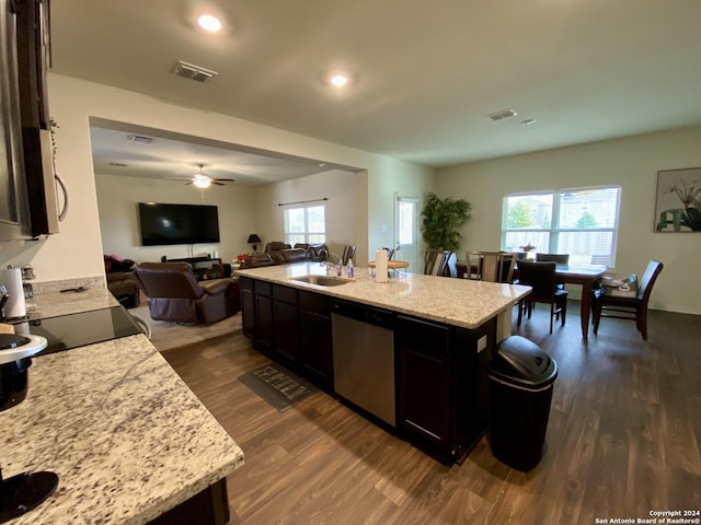 kitchen featuring sink, stainless steel dishwasher, ceiling fan, dark hardwood / wood-style floors, and an island with sink