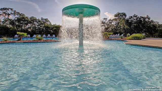 view of pool with pool water feature