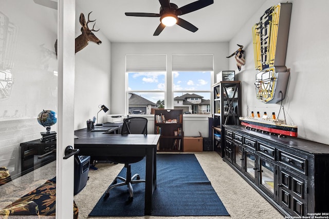 carpeted office space featuring ceiling fan