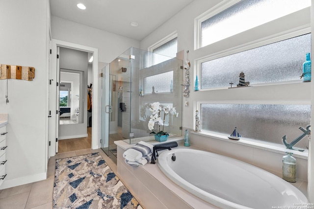 bathroom with tile patterned flooring, vanity, and shower with separate bathtub