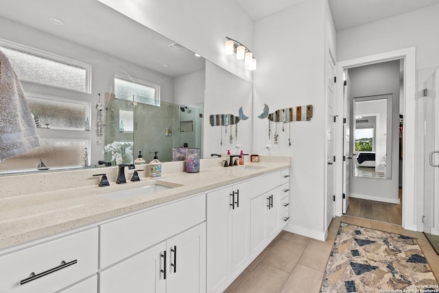 bathroom with vanity, a healthy amount of sunlight, and walk in shower