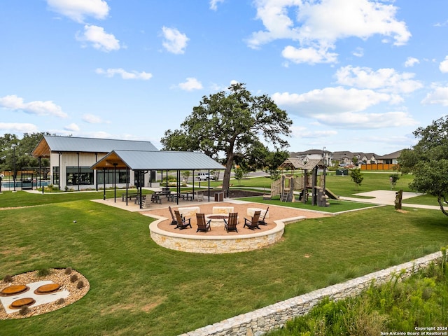 view of property's community with a yard and a playground