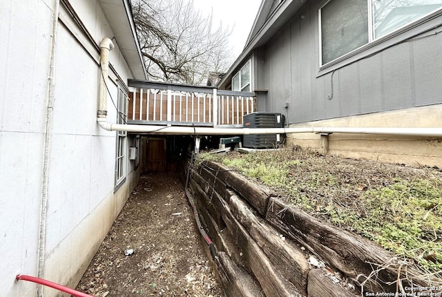 view of side of home featuring central AC