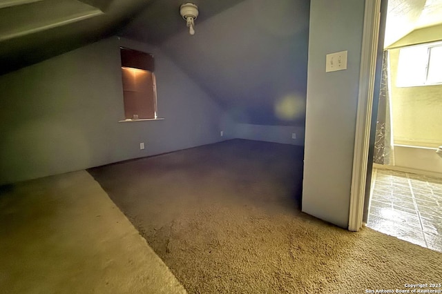 additional living space with lofted ceiling and carpet floors