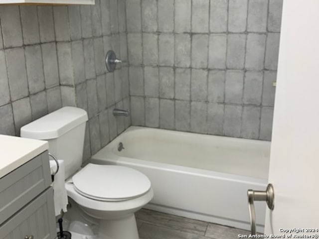 full bathroom with vanity, tub / shower combination, and toilet