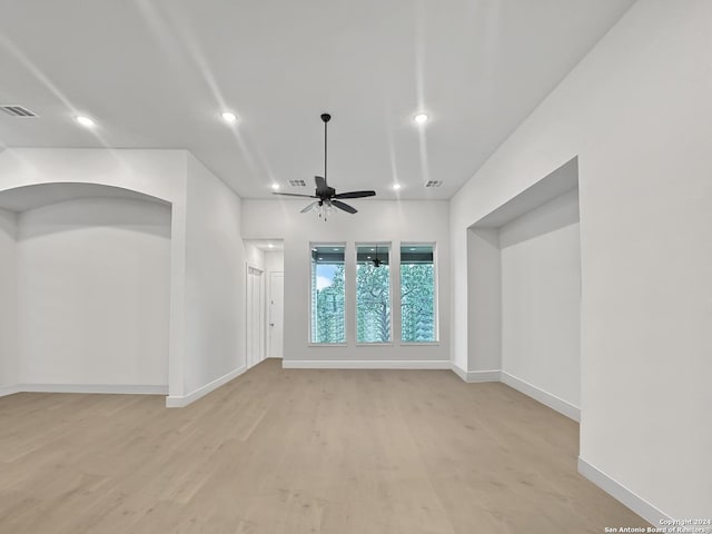 unfurnished living room with light wood-type flooring and ceiling fan