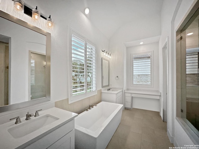 bathroom featuring independent shower and bath, vanity, tile patterned floors, and lofted ceiling