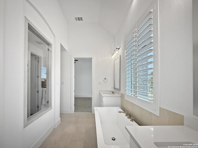 bathroom with vanity, wood-type flooring, and lofted ceiling