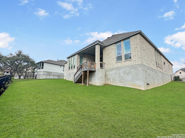 rear view of property with a lawn