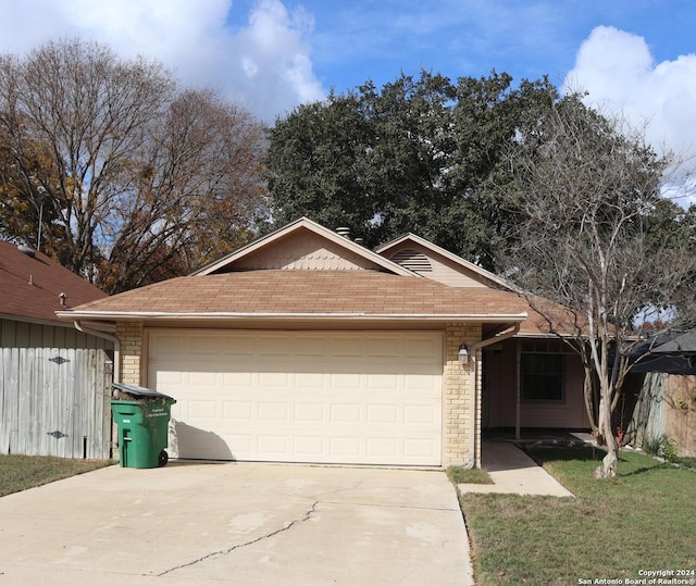 12047 Stoney Brg, San Antonio, TX 78247 - ranch-style house featuring concrete driveway, a garage, a front lawn, and roof with shingles