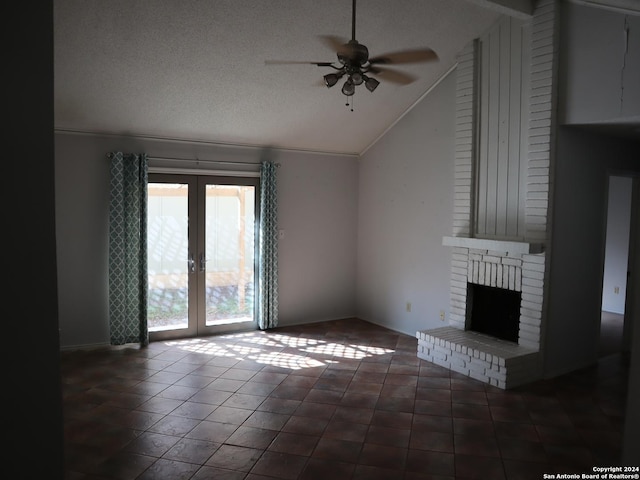 unfurnished living room with french doors, a brick fireplace, ceiling fan, dark tile patterned floors, and a textured ceiling